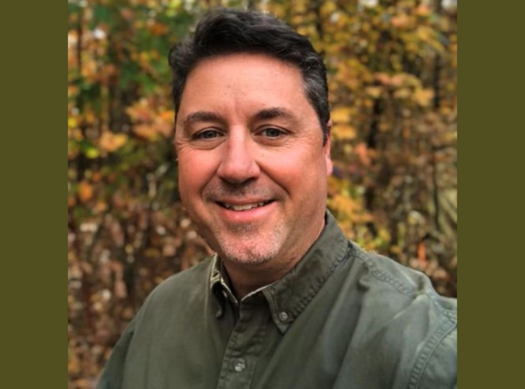 Portrait of man in green shirt, Kyle Cunningham, Arkansas State Forester