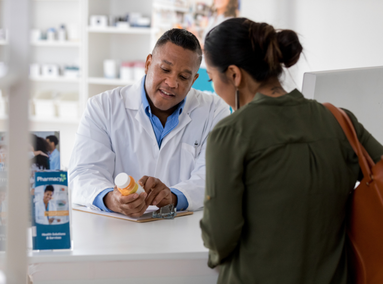 pharmacists consulting a patient at a pharmacy