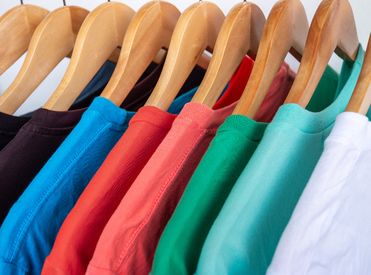 Closeup of a rack of multiple color tee shirts