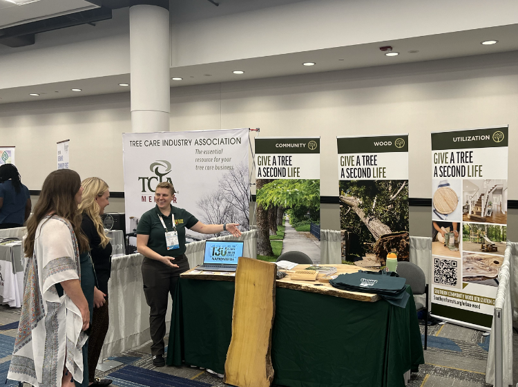 Staff member speaks to exhibit visitors