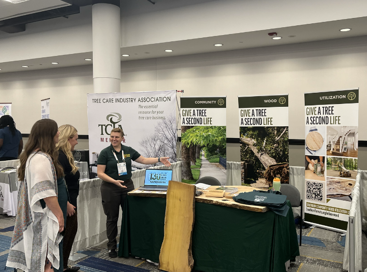 Staff member speaks to exhibit visitors