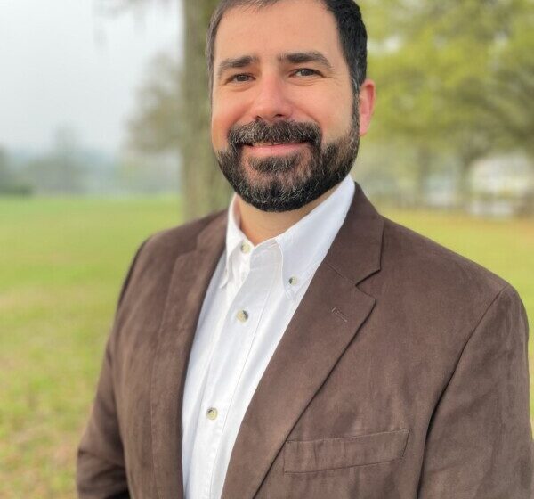 Portrait of a bearded man in a suit jacket