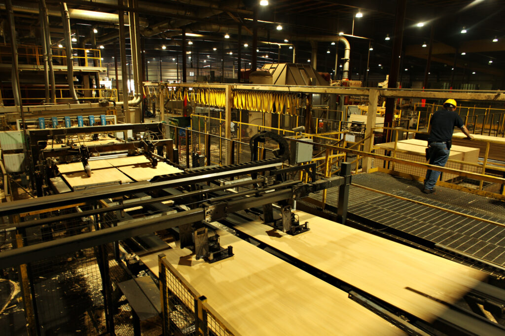 Sheets of OSB exit the press at Norbord's wood production facility in Kinards, South Carolina on August 1, 2013. [Photograph by Joel Prince]
