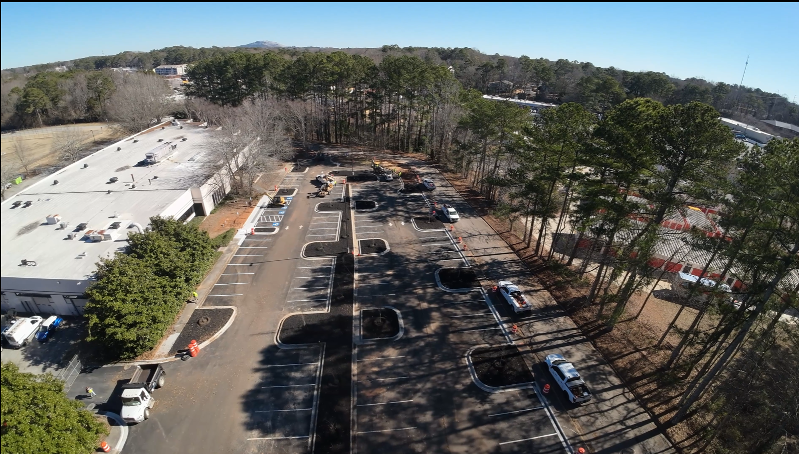 After image showing parking lot with new areas for growing trees and plenty of shade