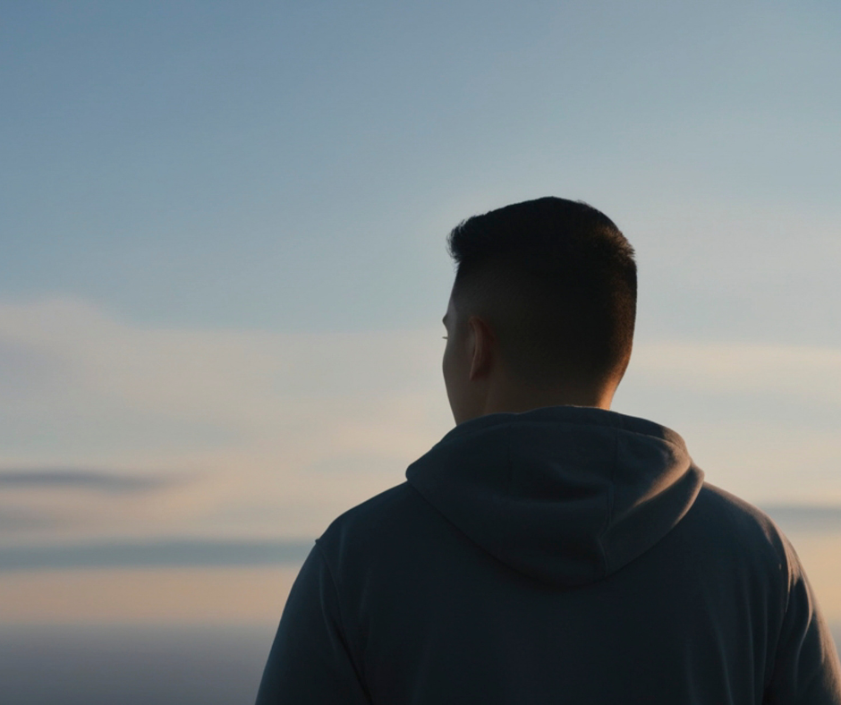 Man Looking at the Horizon During Sunset